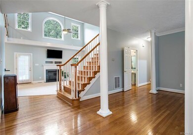 Foyer view into family room, half bathroom and liv