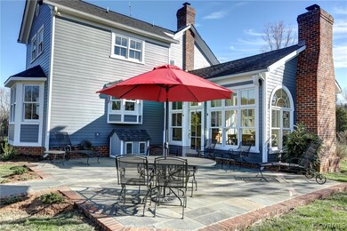 Blue Stone Patio trimmed with brick sits outside f