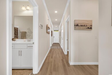 Hallway with baseboards, light wood finished floor
