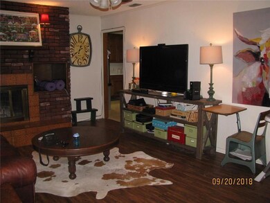 Living room lookng into kitchen area with room for