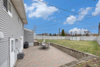 Backyard with a patio area, a storage shed, and grilling area