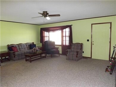 The living room is spacious and features a large picture window with ample natural light