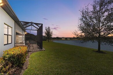 Yard at dusk featuring a water view and a lanai