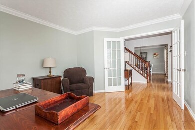 Leading from the entryway, the french doors open i