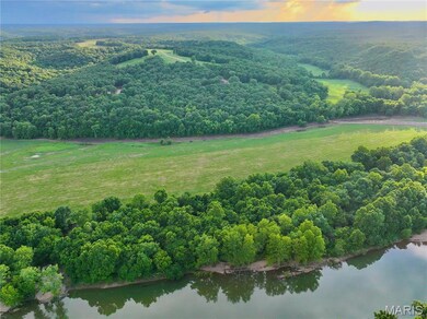 Aerial view at dusk of a water view, a view of countryside, and a wooded view