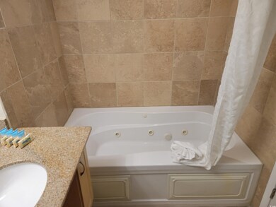 Full bathroom featuring vanity and a combined bath / shower with jetted tub
