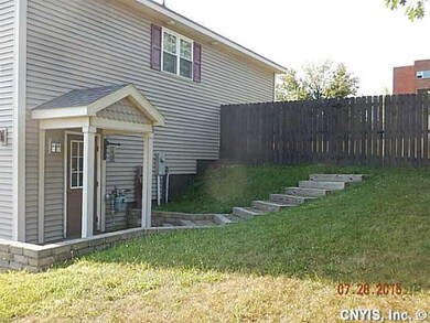 Exterior Front. Side of house w/ steps to fenced i