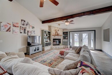 Living room with lofted ceiling with beams, light 