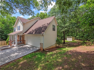 View of property exterior with an attached garage,