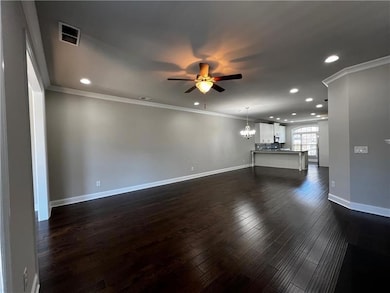 Unfurnished living room with a ceiling fan, recess