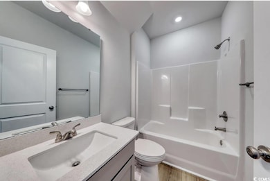 Full bathroom featuring vanity, wood-type flooring