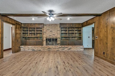 New flooring with gas fireplace and built in book cases