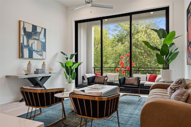 Sitting room with wood finished floors, plenty of natural light, and a ceiling fan