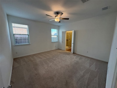Unfurnished bedroom featuring carpet and a ceiling fan