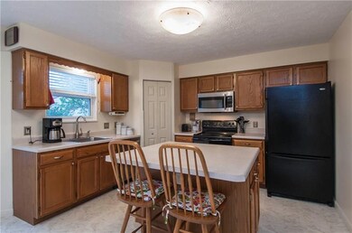 Large eat in kitchen with counter bar. There is al