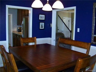 FORMAL DINING ROOM WITH CHAIR RAIL.