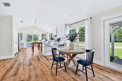 Dining space featuring lofted ceiling, plenty of natural light, and light wood-type flooring