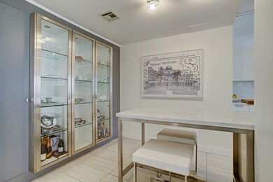 Beautiful glass cabinetry off kitchen.