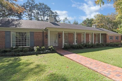 Brick walk takes you to the inviting front porch.