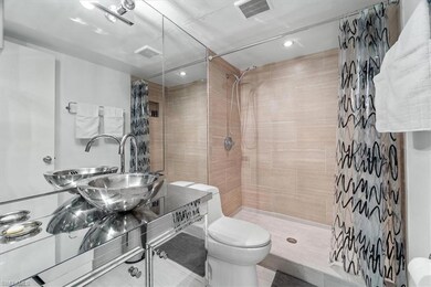 Full bath with visible vents, toilet, vanity, and 