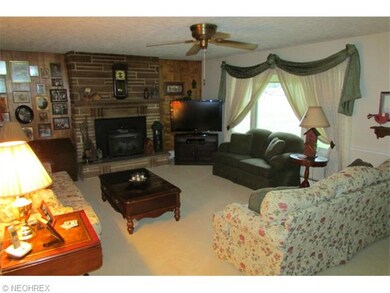 The living room has a wood burning insert and sand