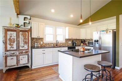 The glass tile backsplash and copper sink are just some of the highlights in here.