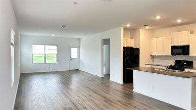 Kitchen featuring black appliances, a sink, dark 