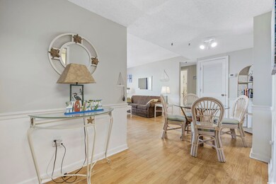 Dining space featuring light wood finished floors and a textured ceiling