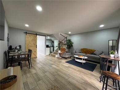 Living room featuring light hardwood / wood-style floors and a barn door