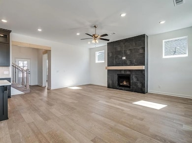 Unfurnished living room featuring baseboards, plenty of natural light, light wood-style flooring, and recessed lighting
