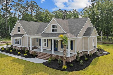 Modern farmhouse style home with a porch, a front lawn, roof with shingles, and board and batten siding