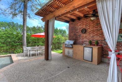 Covered summer kitchen is complete with new gas grill (5.2021) and refrigerator, perfect for outdoor living and entertaining.