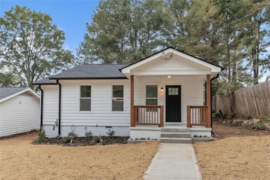 View of front of property with a porch, roof with shingles, and crawl space