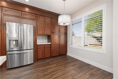 Kitchen with stainless steel fridge, baseboards, d