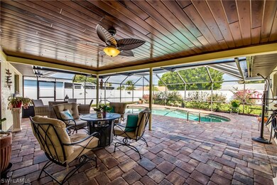 Stunning cypress ceiling on covered lanai area was added by owner, along with paver pool deck. Covered area is just outside of kitchen. 2 sets of pocket sliders, pool bath, and kitchen pass through window allow for easy entertaining.