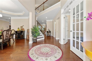 Foyer with stairway, wood finished floors, french 