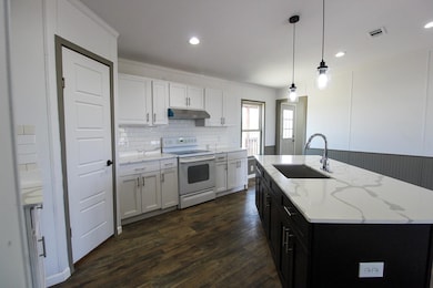 Kitchen featuring white range with electric stove