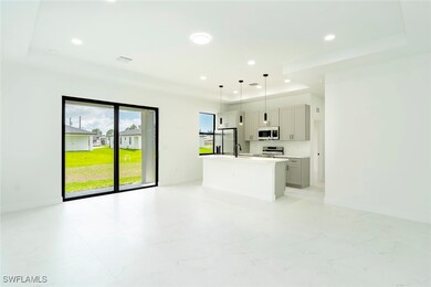 Unfurnished living room featuring a raised ceiling