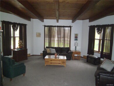 Large living room accented with beautiful wood ceiling and beams