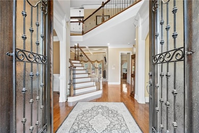 The two-story foyer features an open, airy design that showcases architectural elegance and provides a breathtaking entrance to the home