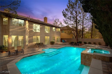 Pool at dusk with fence, an in ground hot tub, a p