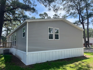 View of side of home featuring cooling unit