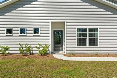 Doorway to property featuring a yard