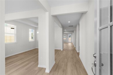 Corridor with plenty of natural light and light wo