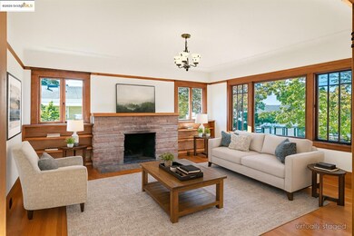 Living area featuring wood finished floors, a fireplace with raised hearth, and a chandelier