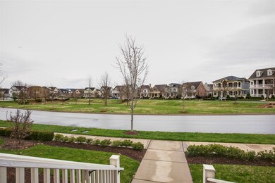 This will be your view from your covered front porch.  Premiere location  overlooking the pond with weeping willows and shade trees! 