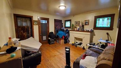 2ND FLOOR UNIT: LIVING ROOM WITH FIREPLACE. ENCLOS