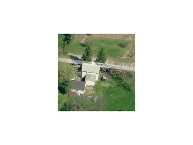 Aerial View. Quiet dead-end street with field acro