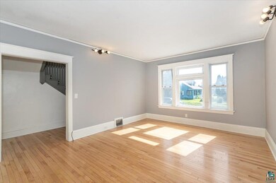 Spare room featuring light hardwood / wood-style f