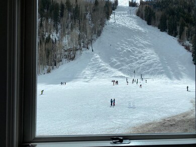 Jilek stumper with skiers and chair lift